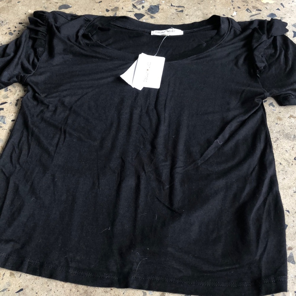 A black tee shirt. Living doll. NWT